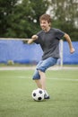 Teenager run soccer football player. Boy with ball on green gr Royalty Free Stock Photo