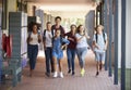 Teenager school kids running in high school hallway Royalty Free Stock Photo