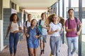 Teenager school kids running in high school hallway Royalty Free Stock Photo