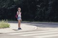 Schoolgirl talking on the phone and walking in pedestrians crossing Royalty Free Stock Photo