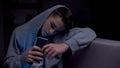 Teenager scrolling phone in darkness, threats from internet, gadget addiction