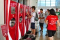 Teenager selecting drink from touch screen of modern vending machine for drinks