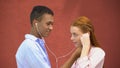 Teenager sharing earphones with girlfriend listening to favorite lyric song