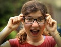 Teenager shortsighted girl with myopia wearing new sight correction glasses Royalty Free Stock Photo