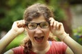 Teenager shortsighted girl with myopia wearing new sight correction glasses