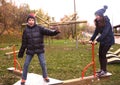 Teenager siblings boy and girl in warm clothes having fun in autumn park