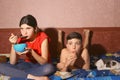 Teenager siblings brother and sister lay on sofa with cat