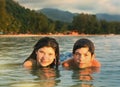 Teenager siblings couple brother and sister swimming in the sea