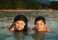 Teenager siblings couple brother and sister swimming in the sea