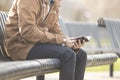 Teenager sitting on bench reading Bible