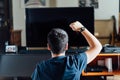 Teenager sitting on the floor at home playing a video game on the console Royalty Free Stock Photo