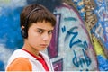 Teenager sitting near a graffiti wall Royalty Free Stock Photo