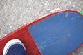 A teenager with a skateboard. Sits on a skateboard. View from above.