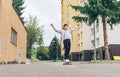 Teenager skateboarder boy in baseball cap riding a skateboard on asphalt street road. Youth generation Freetime spending and an Royalty Free Stock Photo