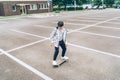 Teenager skateboarder boy riding a skateboard on asphalt playground with white lines doing tricks. Youth generation Freetime Royalty Free Stock Photo