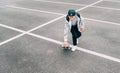 Teenager skateboarder boy with a skateboard on asphalt playground doing tricks. Youth generation Freetime spending concept image Royalty Free Stock Photo