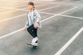 Teenager skateboarder boy with a skateboard on asphalt playground doing tricks. Youth generation Freetime spending concept image Royalty Free Stock Photo