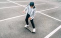 Teenager skateboarder boy with a skateboard on asphalt playground doing tricks. Youth generation Freetime spending concept image Royalty Free Stock Photo