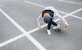 Teenager skateboarder boy with a skateboard on asphalt playground doing tricks. Youth generation Freetime spending concept image Royalty Free Stock Photo