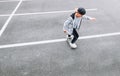 Teenager skateboarder boy with a skateboard on asphalt playground doing tricks. Youth generation Freetime spending concept image Royalty Free Stock Photo