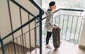 Teenager skateboarder boy with a skateboard going up by staircase home. Youth generation Freetime spending concept image Royalty Free Stock Photo