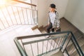 Teenager skateboarder boy with a skateboard going up by staircase home. Youth generation Freetime spending concept image