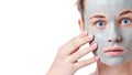 Teenager skincare concept. Young teen girl with dried clay facial mask making funny face Royalty Free Stock Photo