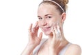 Teenager skincare. Smiling beautiful redhead teen girl with freckles and blue eyes using foaming cleanser.