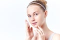 Teenager skincare. Smiling beautiful teen girl with freckles and blue eyes using foaming cleanser. Face washing concept Royalty Free Stock Photo