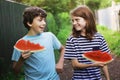 Teenager smiling boy friends hold water melon slice eating