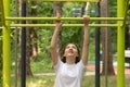 Teenager sport at school and college, teen girl doing sports exercises in a street gym Royalty Free Stock Photo