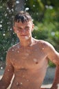 Teenager in a spray of water. Royalty Free Stock Photo