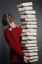 Teenager with stack of books