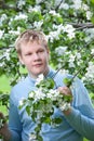 Teenager standing near blossoming apple tree. Royalty Free Stock Photo