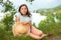 Teenager with a straw hat in the wild