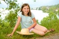 Teenager with a straw hat in the wild