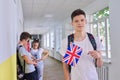 Teenager student with British flag, school corridor group of students background Royalty Free Stock Photo