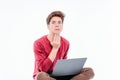 Teenager student with funny face working at laptop on white background