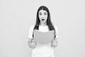 Teenager student girl isolated on yellow background. Cheerful young woman student in shirt hold notebooks showing. High Royalty Free Stock Photo