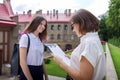 Teenager student girl talking with teacher, woman with clipboard Royalty Free Stock Photo