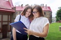 Teenager student girl talking with teacher, woman with clipboard Royalty Free Stock Photo