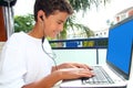 Teenager student happy boy laptop earphones Royalty Free Stock Photo