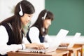 Teenager student learning online with headphones and laptop Royalty Free Stock Photo