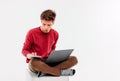 Teenager student with working at laptop and tablet on white background Royalty Free Stock Photo