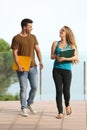 Teenager students boy and girl walking towards camera