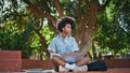 Teenager studying remote class using laptop sitting park. Girl doing homework Royalty Free Stock Photo