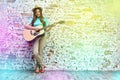 Teenager style portrait of young woman playing acoustic guitar Royalty Free Stock Photo
