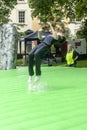 Teenager summersaulting on inflatable Stonehenge