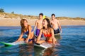 Teenager surfer boys and girls swimming ove surfboard