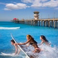 Teenager surfers running jumping on surfboards